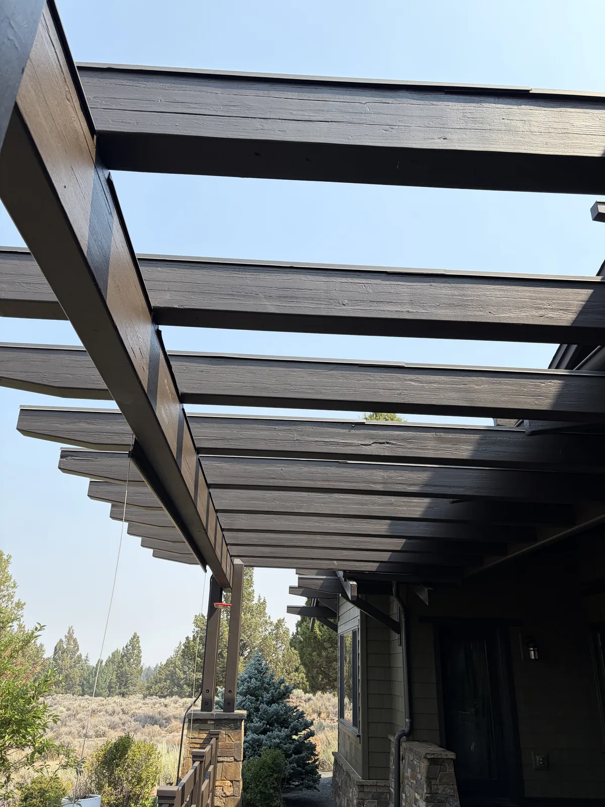 Timber beam ends and overhang above the back patio