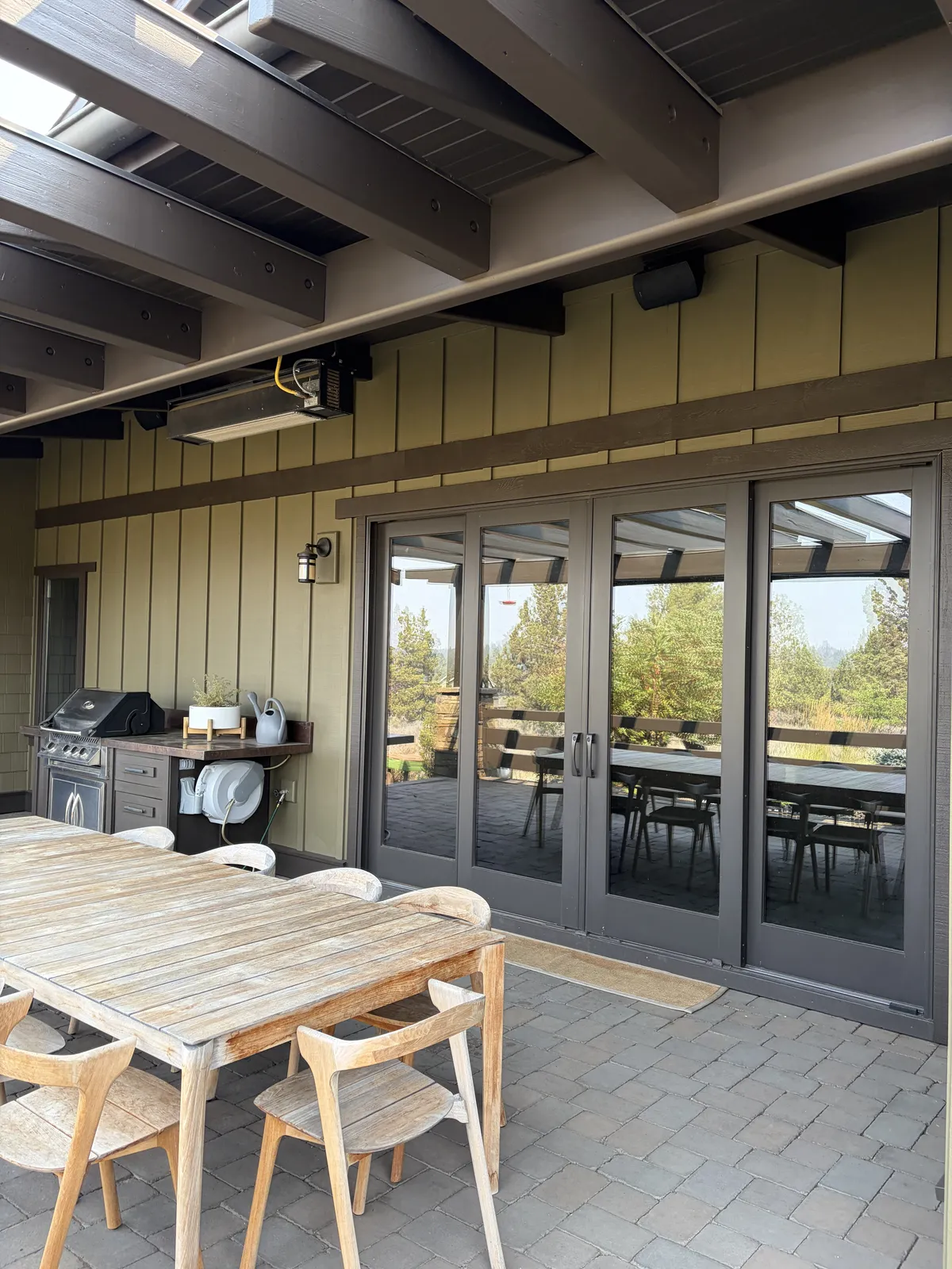 Patio beams above the outdoor table and French doors