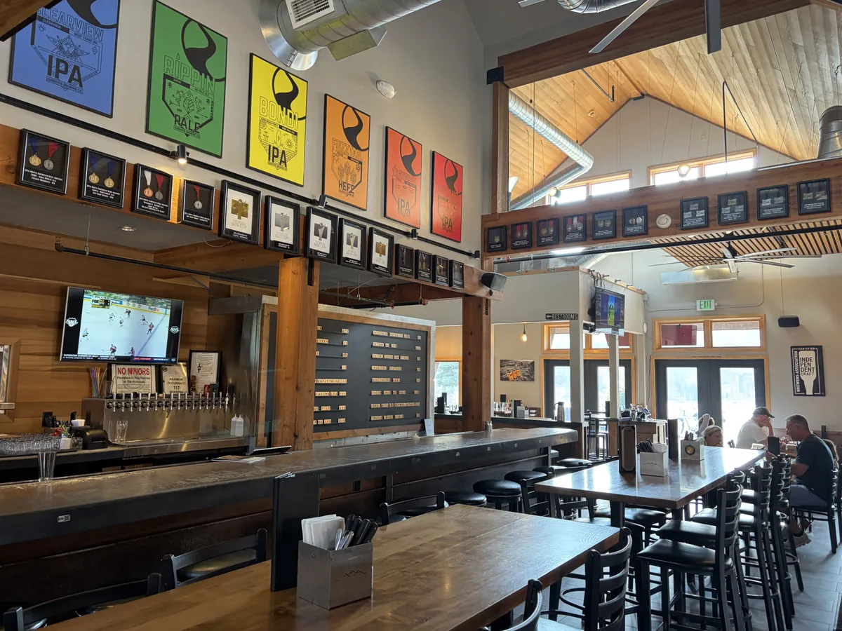 Sunriver Brewing bar with the tap list, timber posts and new tile floor
