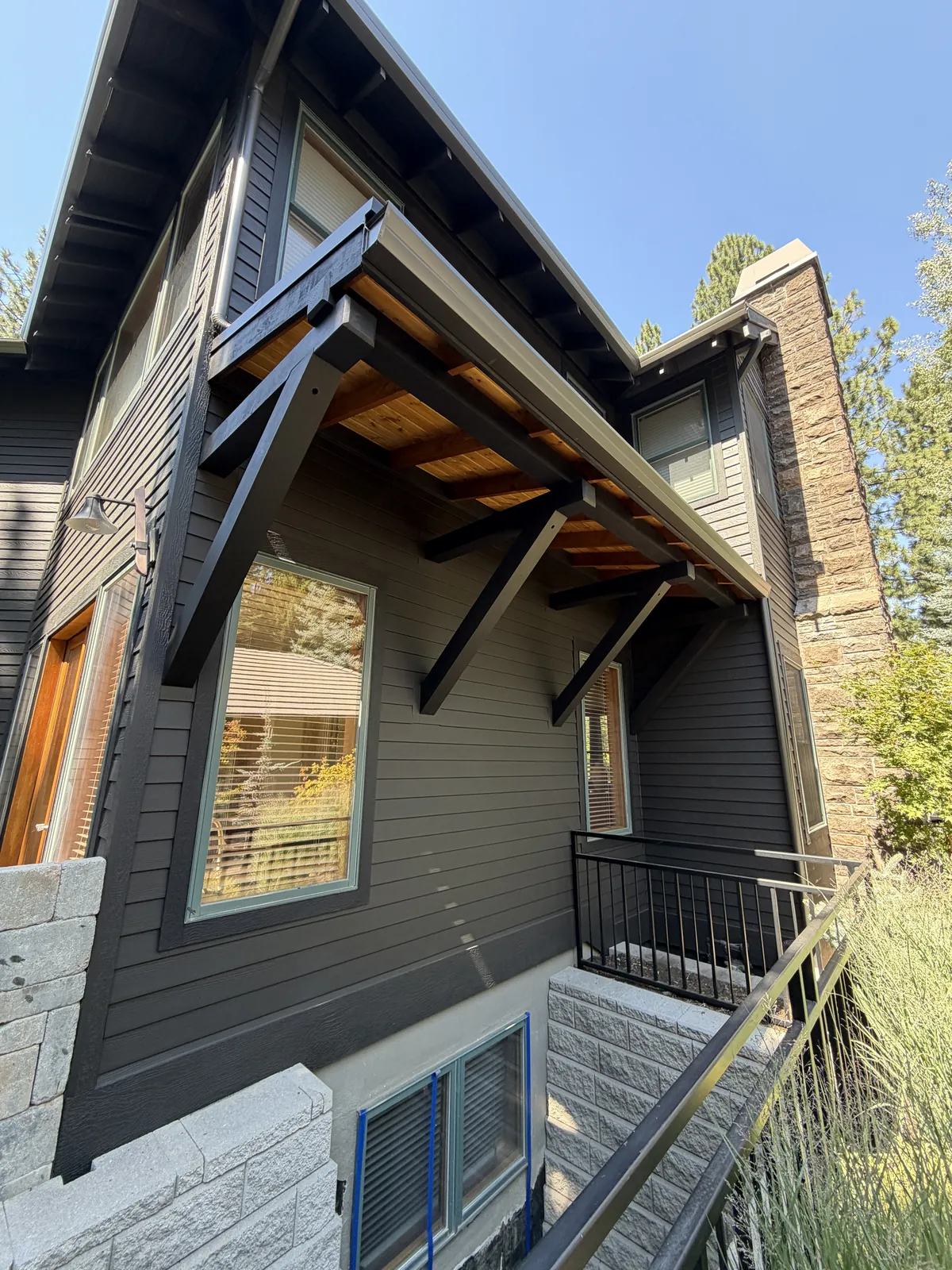 Timber canopy bracket and new siding at the Broken Top home