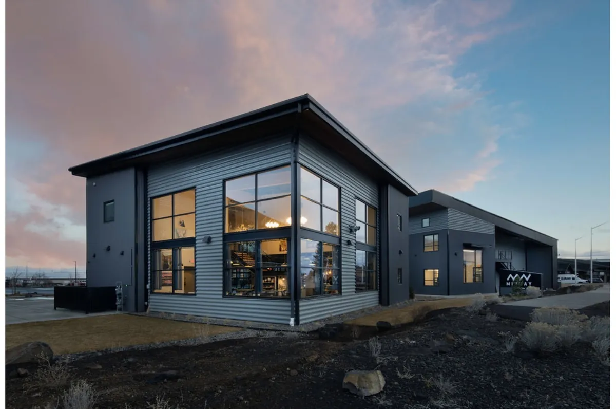 Two-story commercial building with metal siding at dusk