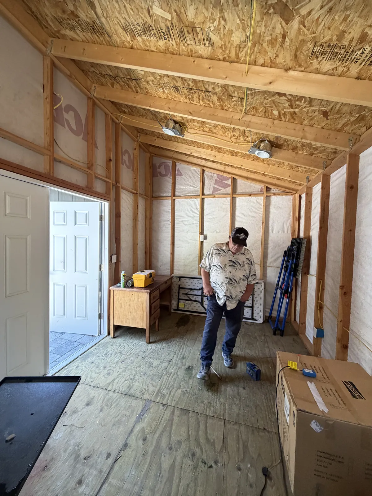 Crew inside a framed structure before drywall