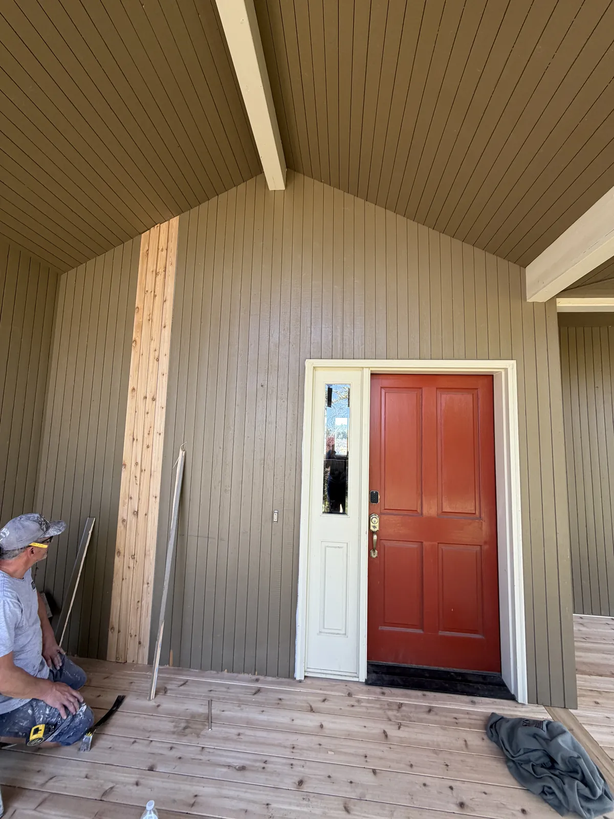 Crew member finishing a new covered porch deck