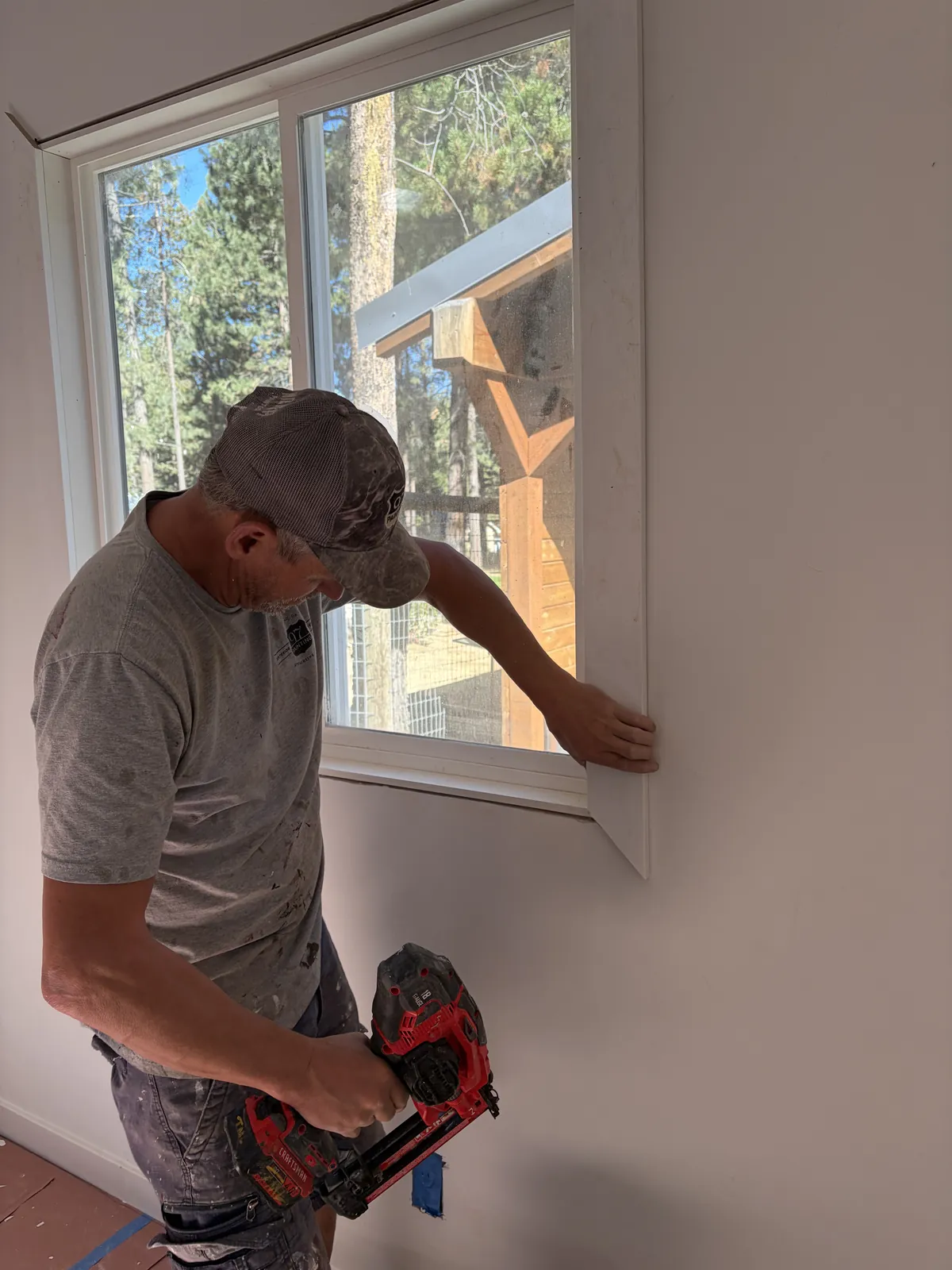 A 97 Builders carpenter trimming a window