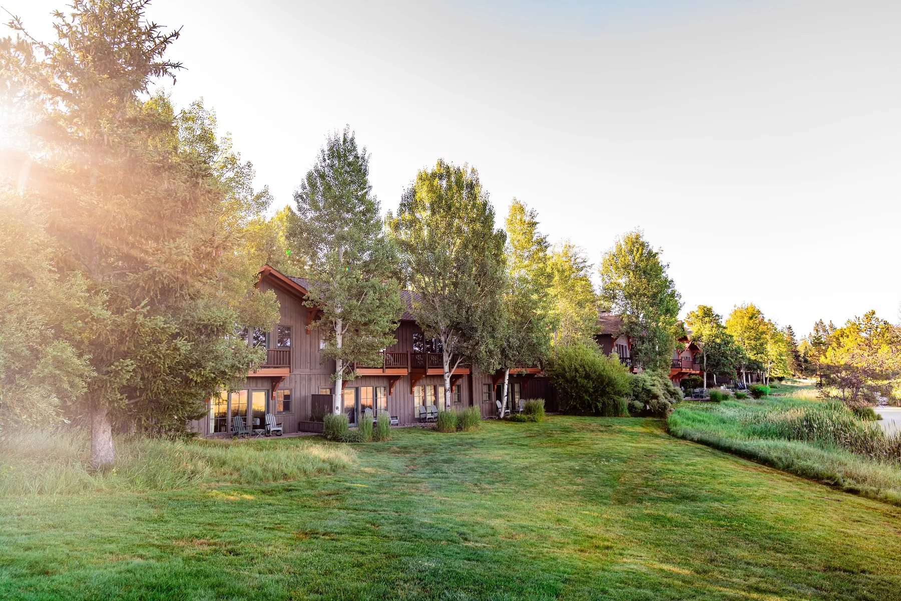 Timber-framed lodging buildings at dawn among pines in Sunriver, Oregon