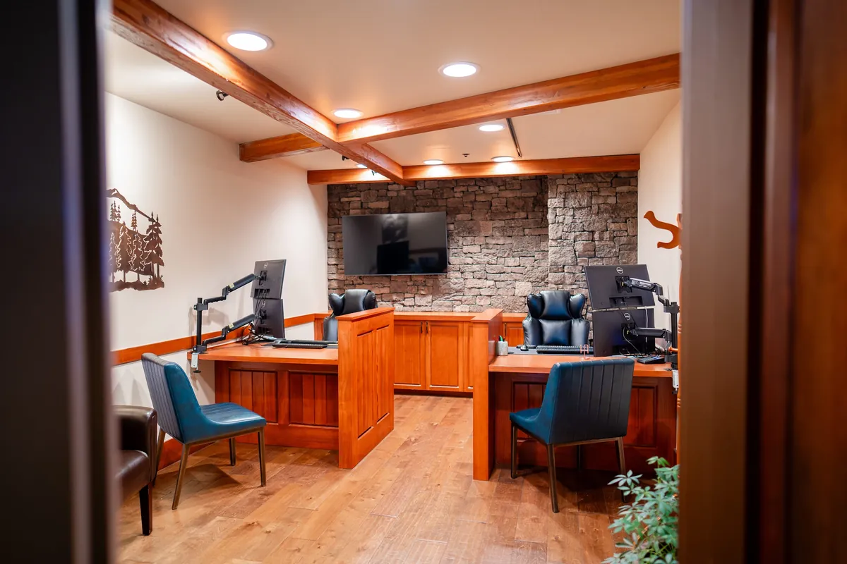 Lodge office after the refresh — new flooring, timber beams and stone accent wall