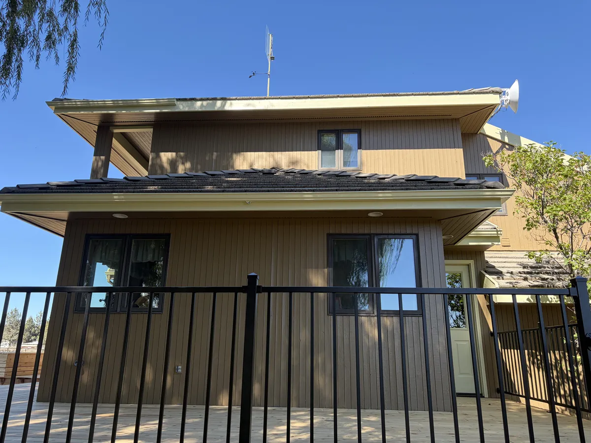 Side of the two-story home after the siding work