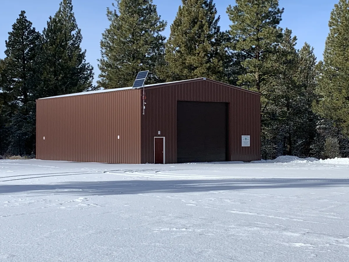 Metal building with roll-up door in the snow